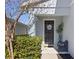 Inviting front entry with a dark door, Hello sign, and potted plant at 1101 Atlantic Ave, Fruitland Park, FL 34731