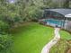 Aerial view of lush lawn, brick path, and pool at 1105 Superior Ct, Winter Springs, FL 32708