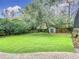 Landscaped backyard with artificial turf and shed at 1105 Superior Ct, Winter Springs, FL 32708