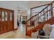 Light-filled entryway with hardwood floors and view of staircase and living area at 1105 Superior Ct, Winter Springs, FL 32708