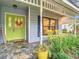 Inviting front porch with yellow rocking chairs and a lime green door at 1105 Superior Ct, Winter Springs, FL 32708