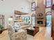 Bright living room showcasing a large brick fireplace and hardwood floors at 1105 Superior Ct, Winter Springs, FL 32708