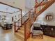 Elegant wooden staircase with a zebra-print chair in the foyer at 1105 Superior Ct, Winter Springs, FL 32708