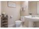 Clean and well-lit bathroom with pedestal sink and toilet at 13805 Bressler Aly, Windermere, FL 34786