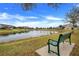 Serene pond with bench overlooking landscaped grounds at 13805 Bressler Aly, Windermere, FL 34786