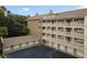 Building with multiple units, parking, and surrounding trees at 1410 Celebration Ave # 101, Celebration, FL 34747