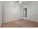 Bright bedroom with neutral carpeting and one window at 1410 Celebration Ave # 101, Celebration, FL 34747