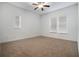 Spacious bedroom with neutral carpet and two windows at 1410 Celebration Ave # 101, Celebration, FL 34747