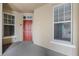 Inviting condo entryway with red door and neutral walls at 1410 Celebration Ave # 101, Celebration, FL 34747