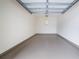 Spacious empty garage with high ceiling and light gray floor at 1410 Celebration Ave # 101, Celebration, FL 34747