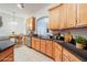 Virtually staged kitchen with light wood cabinets and granite counters at 1410 Celebration Ave # 101, Celebration, FL 34747