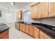 Kitchen with light wood cabinets and granite countertops at 1410 Celebration Ave # 101, Celebration, FL 34747