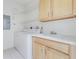 Laundry room with washer, dryer, and cabinets at 1410 Celebration Ave # 101, Celebration, FL 34747