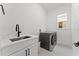 Laundry room with washer, dryer, and sink at 14255 Spring Garden Dr, Winter Garden, FL 34787