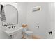 Stylish powder room with a white pedestal sink and black accents at 14255 Spring Garden Dr, Winter Garden, FL 34787