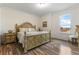 Bedroom with wood-look floors, a large bed, and a window with a view at 16669 Varone Cove Ct, Winter Garden, FL 34787