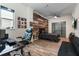 Bedroom with wood-look floors, built-in workspace, and sliding glass doors at 16669 Varone Cove Ct, Winter Garden, FL 34787