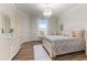 Spacious bedroom with large bed and wood floors at 16669 Varone Cove Ct, Winter Garden, FL 34787