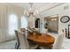 Spacious dining room with an oval table and chandelier at 16669 Varone Cove Ct, Winter Garden, FL 34787