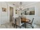 Bright dining room features an oval table and chandelier at 16669 Varone Cove Ct, Winter Garden, FL 34787