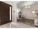 Elegant entryway with a dark brown door and a fireplace at 16669 Varone Cove Ct, Winter Garden, FL 34787