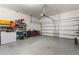 Attached garage with storage shelving and space for multiple vehicles at 16669 Varone Cove Ct, Winter Garden, FL 34787