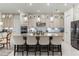 Elegant kitchen with a large island, high-end appliances, and stylish light fixtures at 16669 Varone Cove Ct, Winter Garden, FL 34787