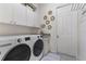 Bright laundry room with LG washer and dryer, and ample cabinet space at 16669 Varone Cove Ct, Winter Garden, FL 34787