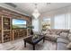 Spacious living room featuring a large TV, comfortable seating, and a beautiful chandelier at 16669 Varone Cove Ct, Winter Garden, FL 34787