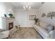 Living room with fireplace, light colored sofa and large windows at 16669 Varone Cove Ct, Winter Garden, FL 34787