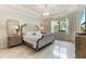 Elegant main bedroom with tufted headboard and large window at 16669 Varone Cove Ct, Winter Garden, FL 34787