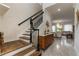 Elegant staircase with dark wood and black iron railing at 16669 Varone Cove Ct, Winter Garden, FL 34787