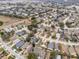 Aerial view of a residential neighborhood with houses and streets at 2041 Black Hawk St, Clermont, FL 34714