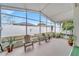 Peaceful screened porch with seating and lush plants at 2041 Black Hawk St, Clermont, FL 34714