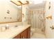 Clean bathroom with tub shower combo and wood vanity at 214 Covent Garden Ave, Davenport, FL 33897