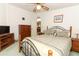 Bright guest bedroom with a bed and wood furniture at 214 Covent Garden Ave, Davenport, FL 33897