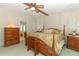 Spacious Primary bedroom with a large bed and wood furniture at 214 Covent Garden Ave, Davenport, FL 33897