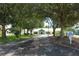 Community clubhouse entrance with tree-lined driveway at 214 Covent Garden Ave, Davenport, FL 33897