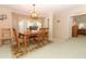 Bright dining room with wooden table and access to other rooms at 214 Covent Garden Ave, Davenport, FL 33897