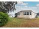 Tan mobile home with screened porch, side yard view at 214 Covent Garden Ave, Davenport, FL 33897