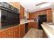 Kitchen with wood cabinets, island, and black appliances at 214 Covent Garden Ave, Davenport, FL 33897