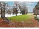 Relaxing lawn area with a park bench overlooking lake at 214 Covent Garden Ave, Davenport, FL 33897