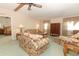 Living room with floral couches, coffee table, and wood cabinet at 214 Covent Garden Ave, Davenport, FL 33897