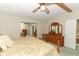 Main bedroom with king-size bed, dresser, and mirrored closet doors at 214 Covent Garden Ave, Davenport, FL 33897