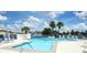 Community pool with ample seating and a sunny day at 214 Covent Garden Ave, Davenport, FL 33897