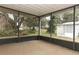 Screened in porch with view of trees and yard at 214 Covent Garden Ave, Davenport, FL 33897