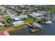 An aerial view showing waterfront homes with backyard pools and boat docks, ready for bay access at 218 S Venetian Way, Port Orange, FL 32127