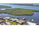 Aerial view showcasing waterfront property, boat docks, and lush landscape at 218 S Venetian Way, Port Orange, FL 32127