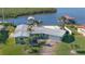 Aerial view of waterfront home with private pool and dock at 218 S Venetian Way, Port Orange, FL 32127