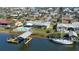 Aerial view of a waterfront home with a private dock and a swimming pool in a coastal community at 218 S Venetian Way, Port Orange, FL 32127